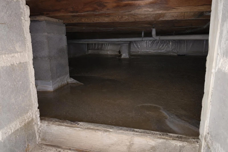 Through the hatch, murky brown water covers a North Salt Lake crawlspace floor and mirrors the joists above